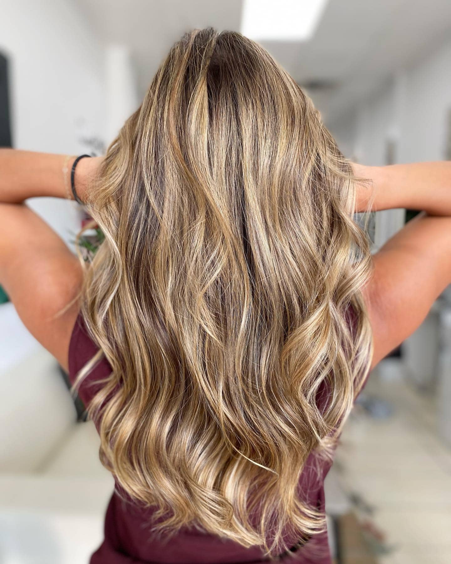 Golden caramel blonde balayage on long hair at Donya Hair + Body
